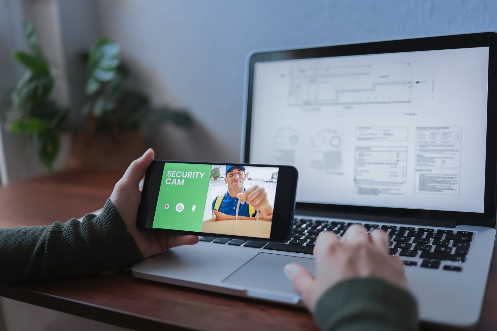 Delivery man ringing door bell on cctv secure camera system on mobile phone app